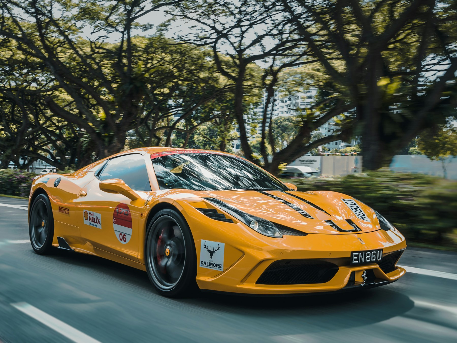 A Ferrari 458 wearing event livery in motion